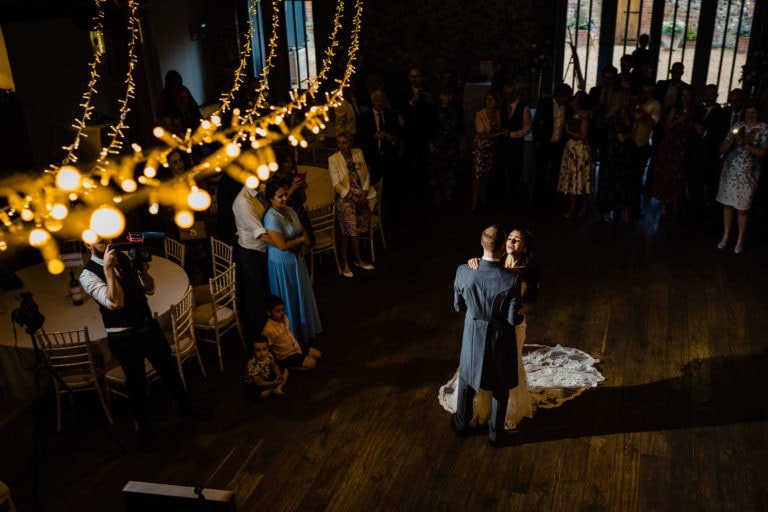 bride and groom dancing at oxnead hall wedding, framed by fairy lights